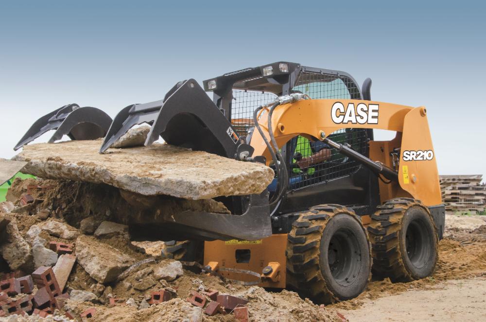 Skid steer moving material during site prep